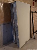 Mattress and box spring standing upright