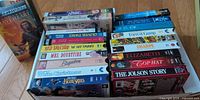 Tray of assorted VHS tapes showing titles and quantities