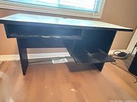 Front view showing desk structure, open knee space, shelves, wear visible