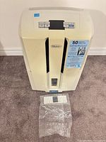 Top view of DeLonghi dehumidifier and separate filter