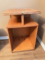 Front view showing open cubby and sliding shelf with brass knob