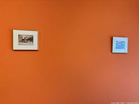 Both framed prints on wall for scale