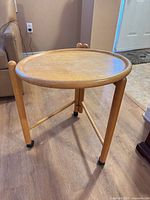 Front three-quarter view of table showing legs, top and cross brace