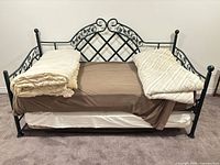 Front view of assembled metal daybed with mattresses