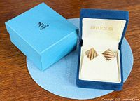 Earrings in Birks box next to outer sleeve