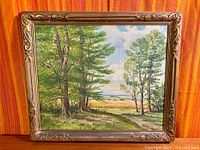 Full view of framed landscape painting