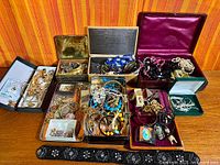 overview of multiple jewelry boxes filled with assorted pieces