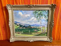 front view of framed landscape painting
