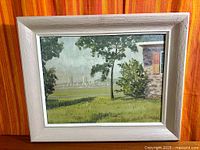 Full view of framed painting against striped curtain