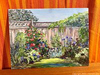 Full view of unframed oil on board painting showing garden scene and signature area