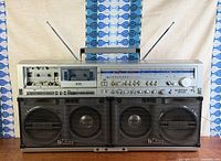 Front view of Sharp GF-777 boombox showing dual speakers, cassette decks, control panel, antennas extended