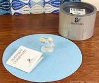 Figurine, box, certificate on surface