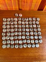 Full layout of 81 Coca-Cola crown caps on tabletop
