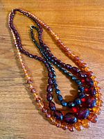 All three necklaces laid out to show colors and graduated bead sizes