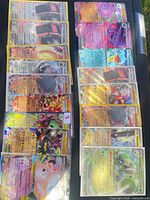 All 14 Pokémon cards laid out in two columns of seven, each in penny sleeve