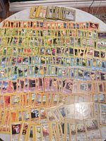 Overview of all 200+ Pokémon cards spread out on table
