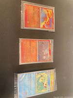Overview of three sleeved cards – Moltres, Reshiram, water-type card