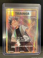 Front of Brock's Grit full art rainbow holo card in top-loader