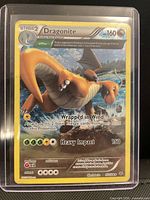 Front of Dragonite holographic card in top-loader