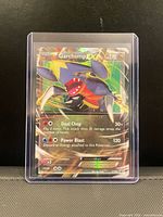 Front view of Garchomp EX full art holo card XY09 in toploader