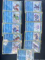 All 11 sleeved shiny cards laid out in two columns
