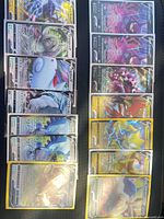 All 14 sleeved cards laid out in two columns