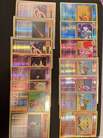 All 16 reverse-holo cards laid out in two columns