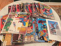 Stack of bagged DC and Marvel comic books on table