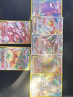 All seven sleeved Pokémon VMAX rainbow cards laid out
