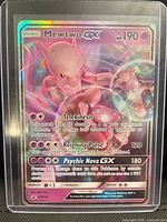 Front of Mewtwo-GX SM196 rainbow full art card in toploader