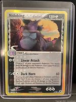 Front view of Nidoking Delta Species holographic card in toploader