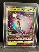 Front of Pheromosa GX SM66 card in toploader showing artwork and holo finish