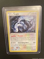 Front of Lugia holographic card in toploader