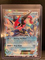 Front of Ash-Greninja EX card showing artwork, stats and holo finish inside top-loader
