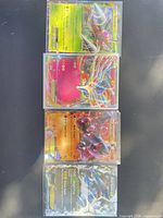 Four sleeved Pokémon EX cards stacked
