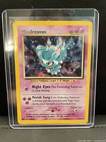 Front view of holographic Misdreavus Neo Revelation card in sleeve