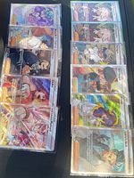 All 12 sleeved full-art Trainer cards displayed in two columns