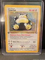 Front view of Snorlax holographic card in top-loader