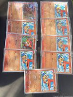 Nine sleeved Pokemon cards laid out showing duplicates of Victini plus two other Fire-type cards