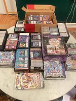 Wide view of all cards, sealed boxes, tins on table