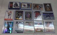 Spread of 15 sleeved cards including Crosby, Roy, holographic and insert designs
