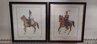 Front view of both framed cavalry prints showing artwork, mats, and frames