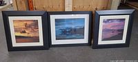 Front view of three framed seascape photographic prints showing images, mats and frames