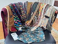 All ties and cummerbund draped over chair for overview