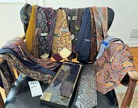 Group shot of all neckties and cummerbunds displayed on chair, boxed cummerbund visible
