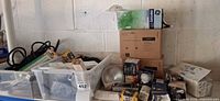 Shelf with bins containing cables, bulb boxes and loose bulbs