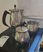 Full view of all three pewter pieces showing design and scale