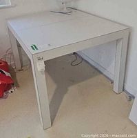 Overall view of white laminate table