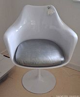 Front view of white tulip swivel chair showing cushion and form