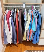 Closet rod with grouping of dress shirts, polos, sweaters